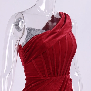 Detail of red velvet off-shoulder dress with silver glitter bodice and structural boning