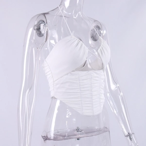 Detail of white halter neck top with ruched texture and crisscross strap design