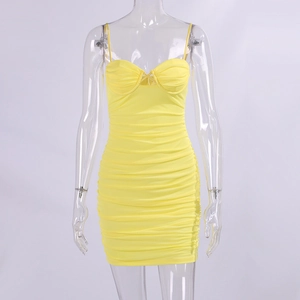 Close-up of vibrant yellow ruched mini dress with thin straps and bodycon fit