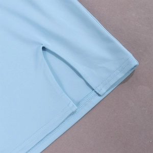 Detail shot of light blue knit skirt featuring a side slit and precise stitching