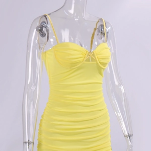 Detail of yellow mesh mini dress with ruched fabric and crossover hollow-out bust design