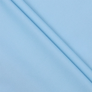 Close-up of light blue ribbed knit fabric showing fine vertical texture and soft elasticity
