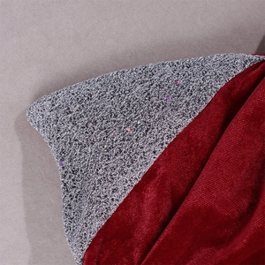 Macro shot showing contrasting red velvet and silver glitter sequins on a party dress