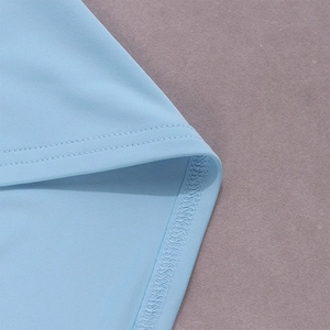 Close-up of double-needle stitching and hem detail on light blue fashion set fabric
