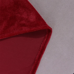 Detail shot of wine red velvet fabric showing smooth texture and high-quality stitching