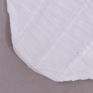 Close-up of white mesh fabric with elegant pleated texture and sheer mesh structure detail