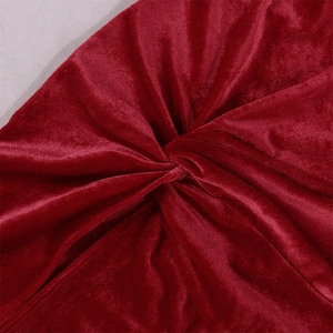 Detailed view of the wine red velvet fabric with elegant twisted knot design