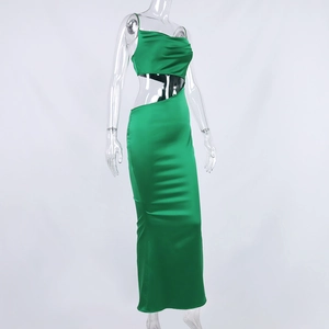 Detailed view of the green satin dress featuring asymmetrical side waist cut-out and long hem