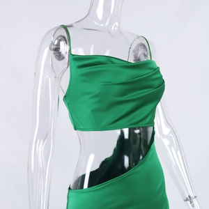 Detail of lime green satin dress featuring cowl neck and side cutout design