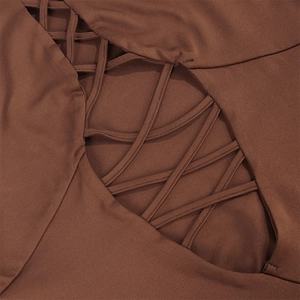 Detail of dark brown dress featuring criss-cross cut-out design and elastic knit fabric