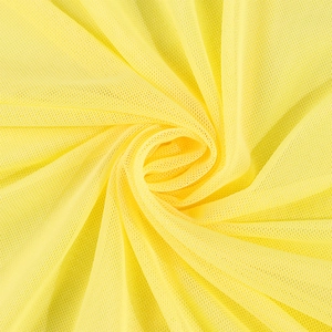 Macro detail of bright yellow mesh fabric with a fine honeycomb mesh structure