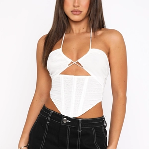 White ruched halter neck corset top with mesh detailing and asymmetrical hemline