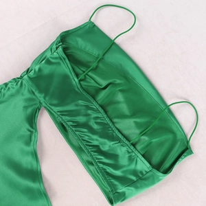 Detailed view of emerald green satin dress featuring thin straps and smooth lining