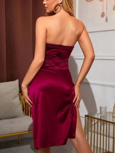 Close-up of invisible zipper closure on wine red satin tube midi dress with side slit