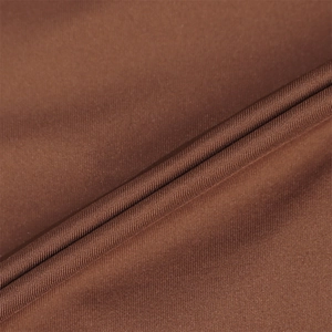 Macro detail of brown twill fabric showing fine texture and smooth drape of the dress