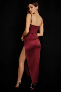 Detail of burgundy satin maxi dress featuring slim straps and high side slit design