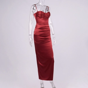 Detail of burgundy satin dress showing delicate ruching and sleek spaghetti straps
