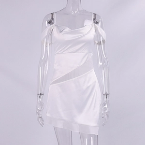Detail view of white satin mini dress featuring sheer mesh inserts and a ruffled hemline