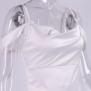 Close-up of white satin dress with delicate spaghetti straps and draped neckline details