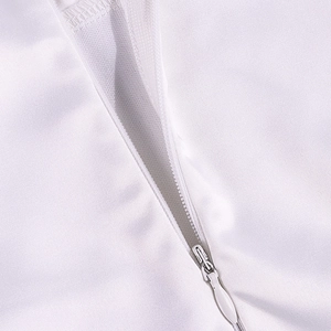 Detail view of high-quality invisible zipper on a white satin dress with mesh lining