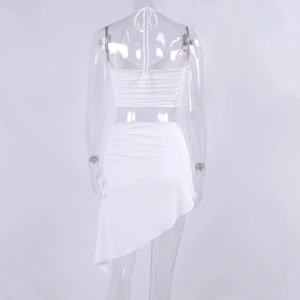 Detail view of white halter top with ruched back lacing and irregular mini skirt
