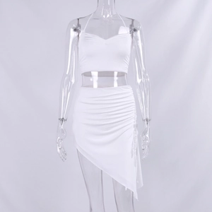 Detail of white two-piece set featuring halter crop top and asymmetric ruched mini skirt