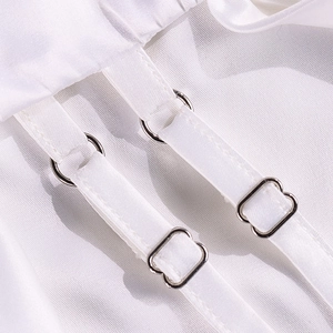Macro shot of white satin camisole dress with adjustable silver metal buckles and straps