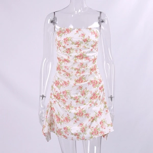 Detail of floral printed mini dress showing ruched fabric and pink rose patterns