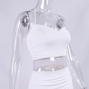 Detail of white two-piece set featuring pleated crop top and ruched bodycon skirt