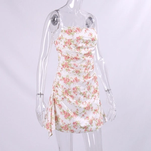 Detail of ruched floral tube dress with pink rose print and ruffled hem for summer