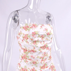 Detailed view of pink rose floral print and ruched texture on a satin tube dress