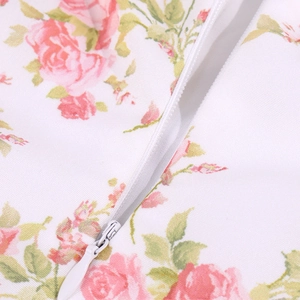 Detail of invisible white zipper on summer dress with floral pink rose print fabric