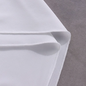 Macro view of white twill fabric texture and neat overlock stitching on the hemline