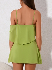 Back view of a lime green chiffon dress featuring layered ruffles and thin spaghetti straps