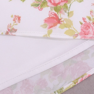 Detailed close-up of pink rose floral print and professional double stitching on hemline