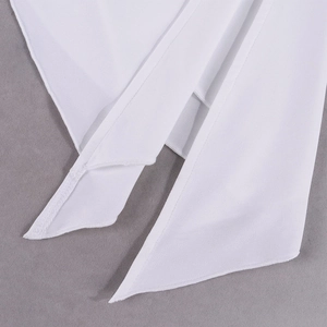 Detail of the high-quality stitching and white fabric texture on this stylish two-piece set