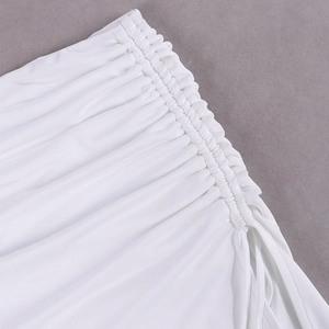 Detailed macro view of white ruched fabric texture and professional stitching on the skirt