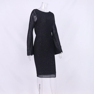 Detail of black mesh long sleeves with sparkling sequins on a fitted party dress