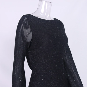 Detail view of black long sleeve dress featuring sparkling sequins and mesh sleeve textures