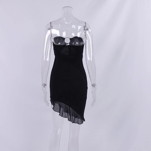 Detail of slim black bodycon dress featuring metal ring bust and ruffle asymmetric hem