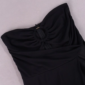 Detail of black mesh dress with ruched bust, gold ring hardware and zipper closure