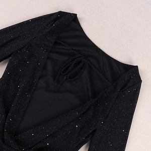 Detailed macro view of black mesh dress featuring shimmering colorful sequins and V-neck tie