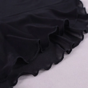 Close-up of black mesh fabric showing breathable texture and wavy lettuce hem details