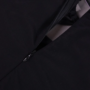 Detail of hidden zipper on black mesh dress showing smooth construction and fabric texture