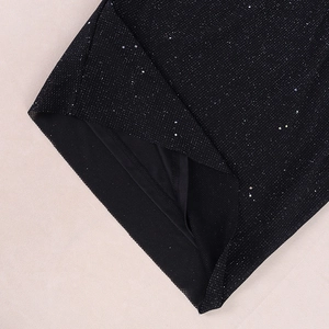 Detailed close-up of sparkling black sequin mesh fabric with smooth inner lining