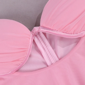 Detail of pink mesh dress featuring underwired cups with ruched fabric and cut-out design