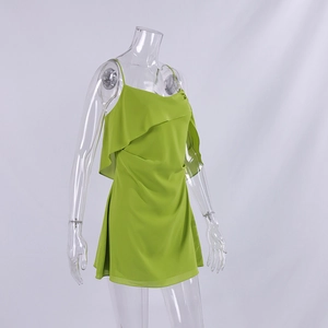 Detail of grass green chiffon dress featuring a layered bust and draped pleat design