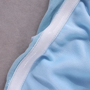 Macro detail of light blue mesh fabric with white elastic band and anti-slip silicone grip