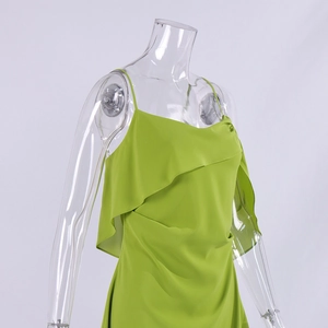 Close-up of bright green chiffon dress featuring delicate straps and ruffle layering detail