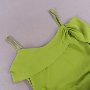 Detail of green chiffon dress showing fine spaghetti straps and ruffled neckline pleats